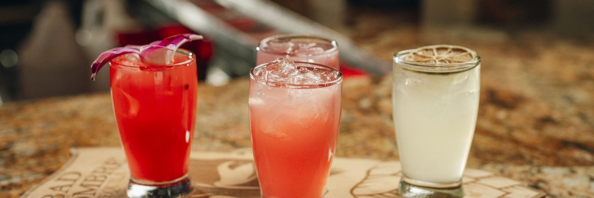A flight of margaritas on a wooden serving board