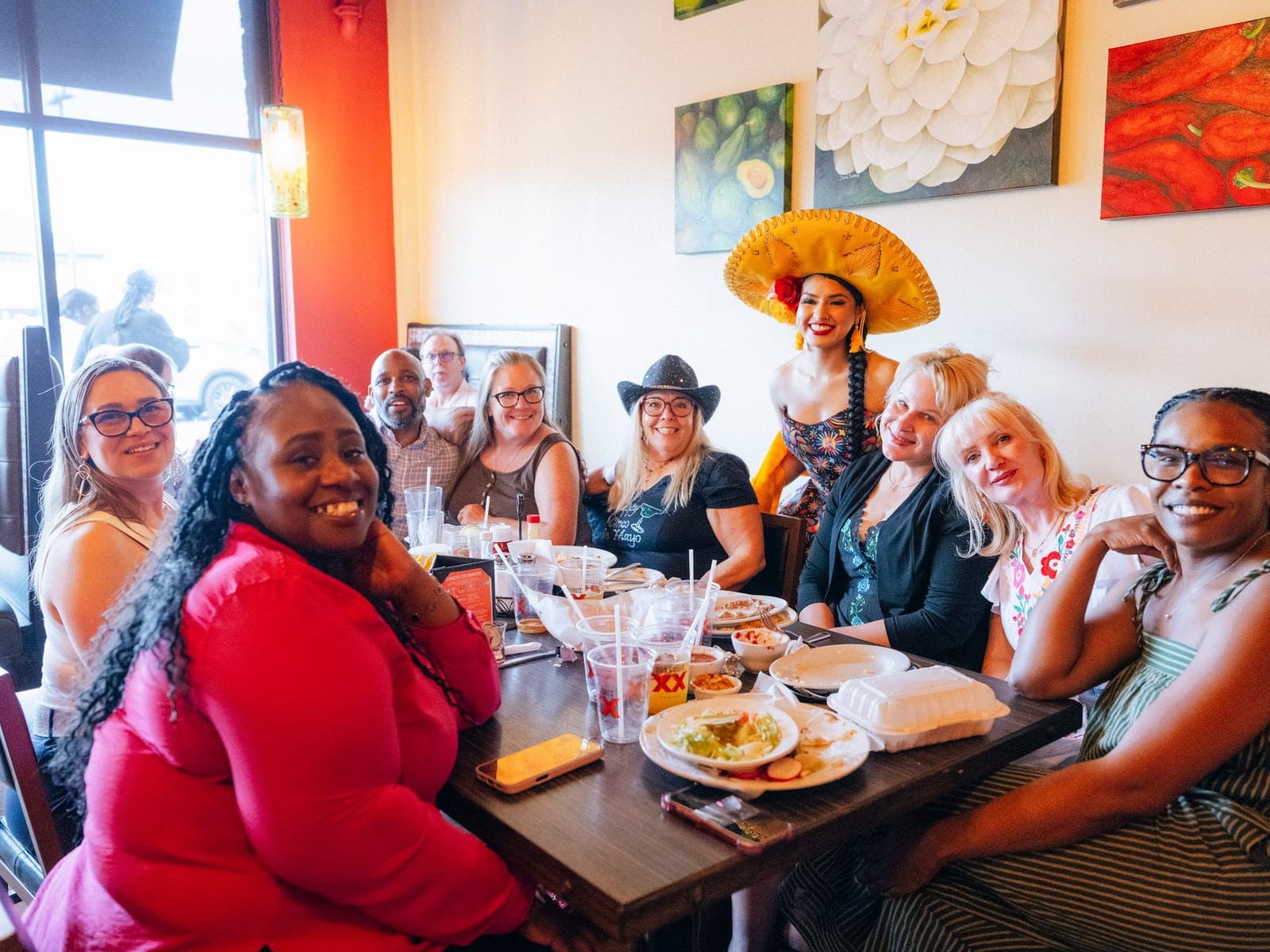 A large group celebrating together at a long table at La Tolteca